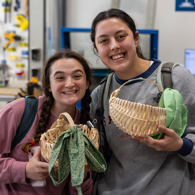 Students holding their finished baskets.