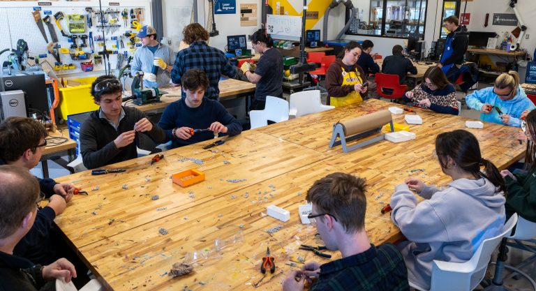 Students around a table working on chainmail