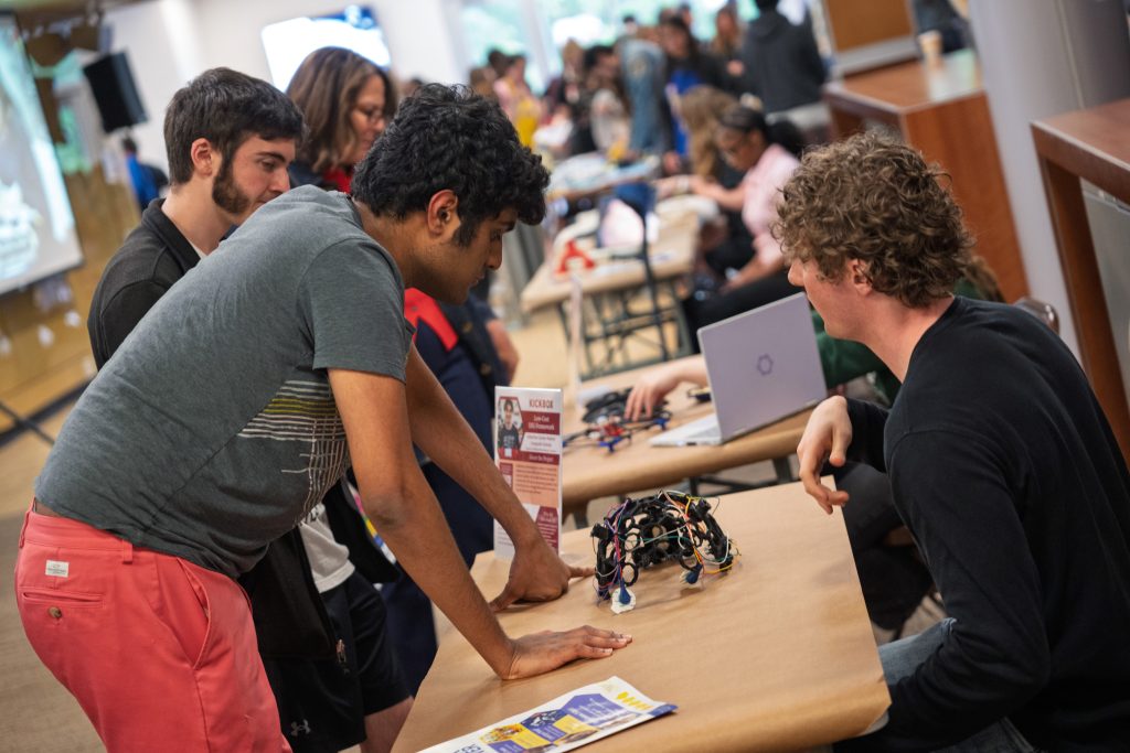 Student sitting at table talking about a project