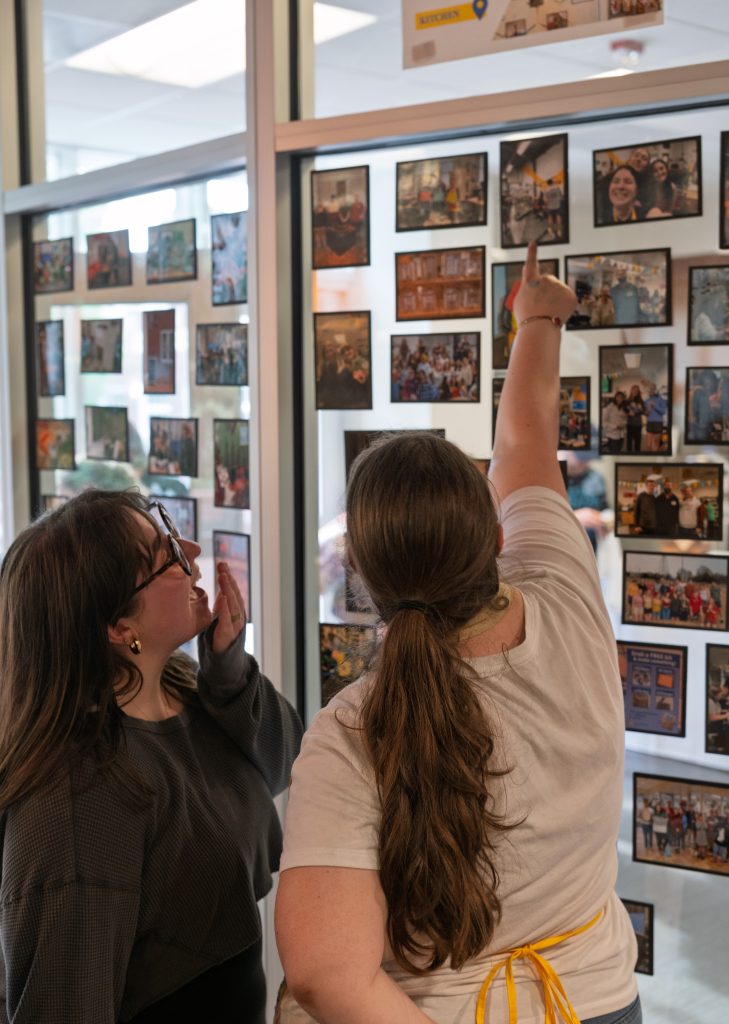 Student pointing to picture on a wall