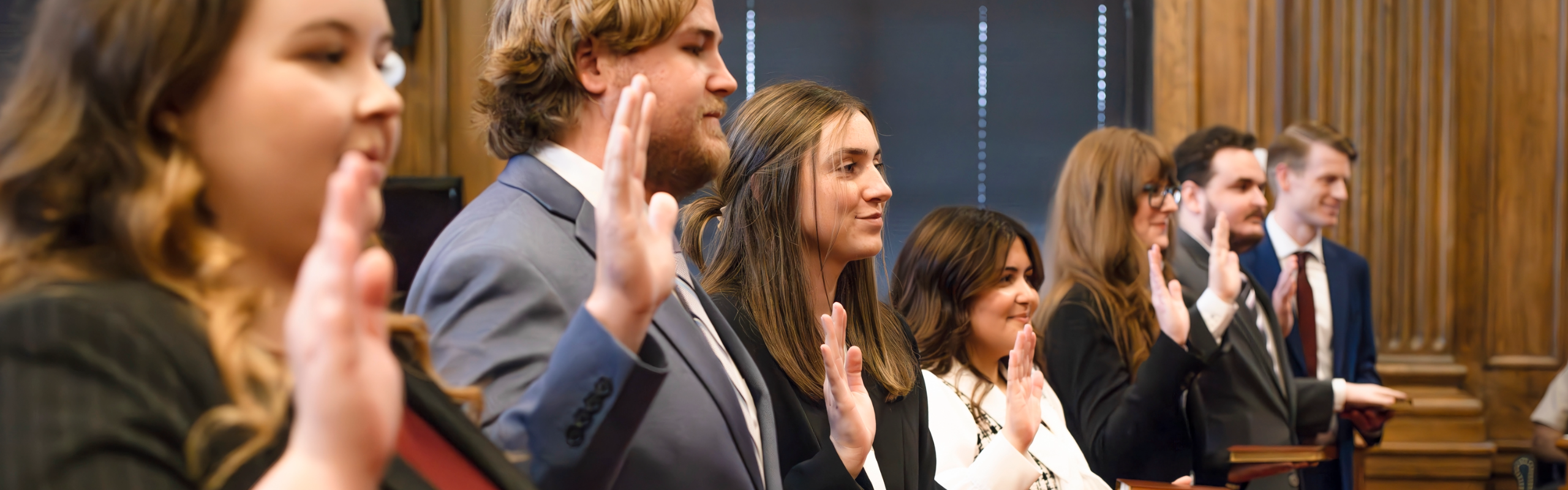 A group of graduates take their oaths as licensed attorneys inside a courtroom. PreLaw Magazine names Elon Law is one of the best law schools in NC for practical training.
