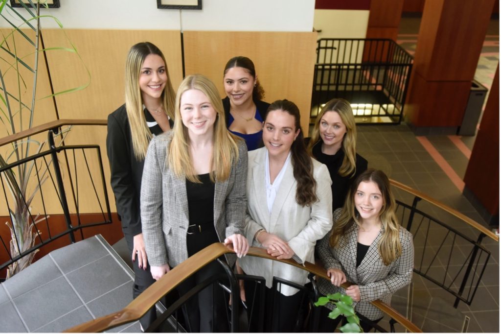 A group of six students on Elon Law's spiral staircase.