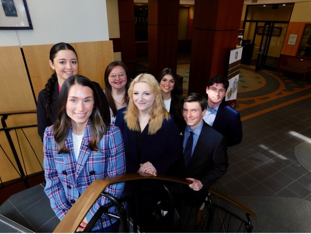 A group of seven students on Elon Law's spiral staircase.