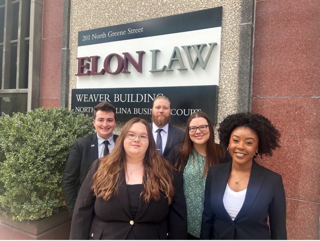 A group of students standing in front on the Elon Law Building