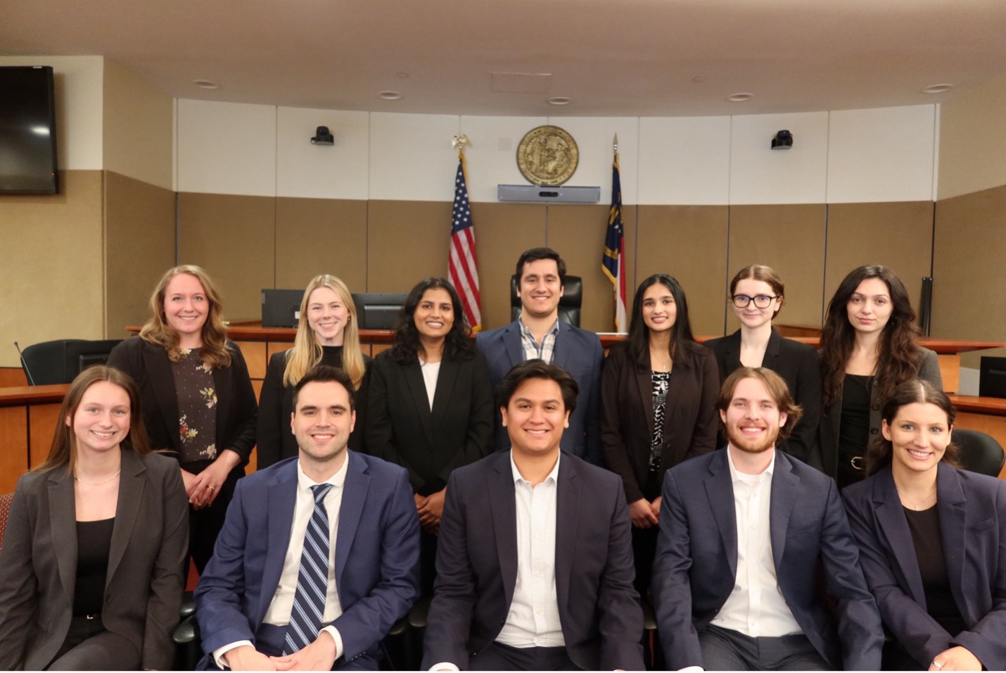 A group of people standing in the ÂÒÂ×ÊÓÆµ Law Business Court