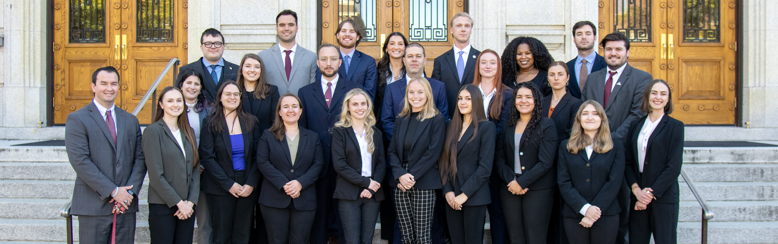 24 ELon Law students in professional dress on the Old Guilford Courthouse steps