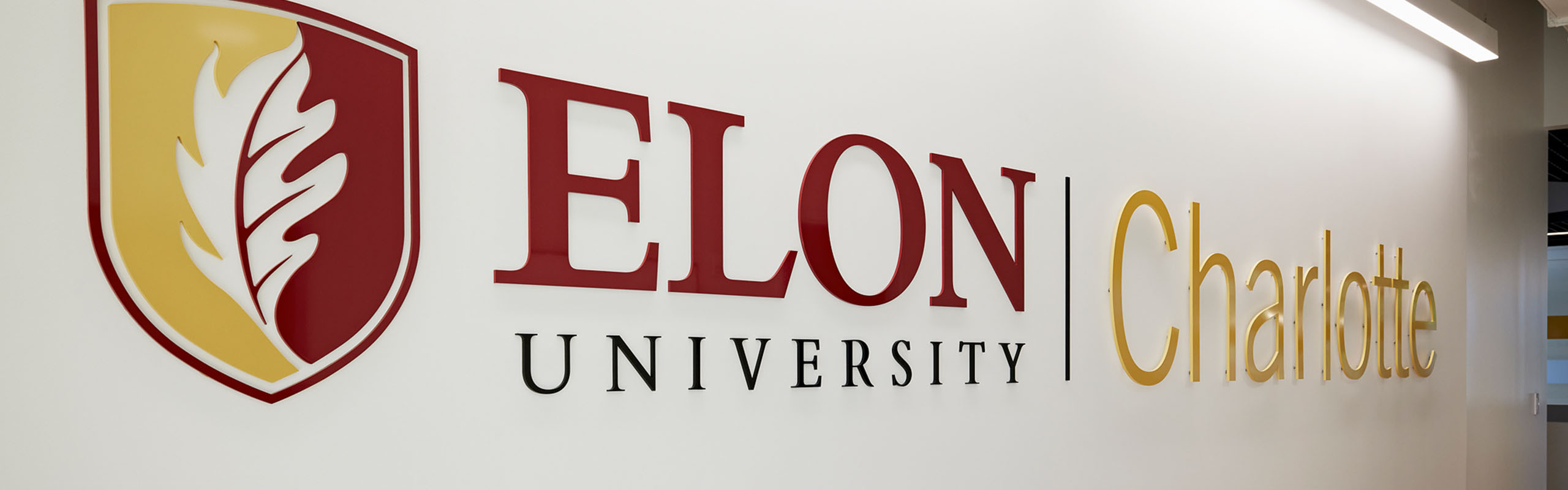 Elon Law Charlotte logo displayed on glass window
